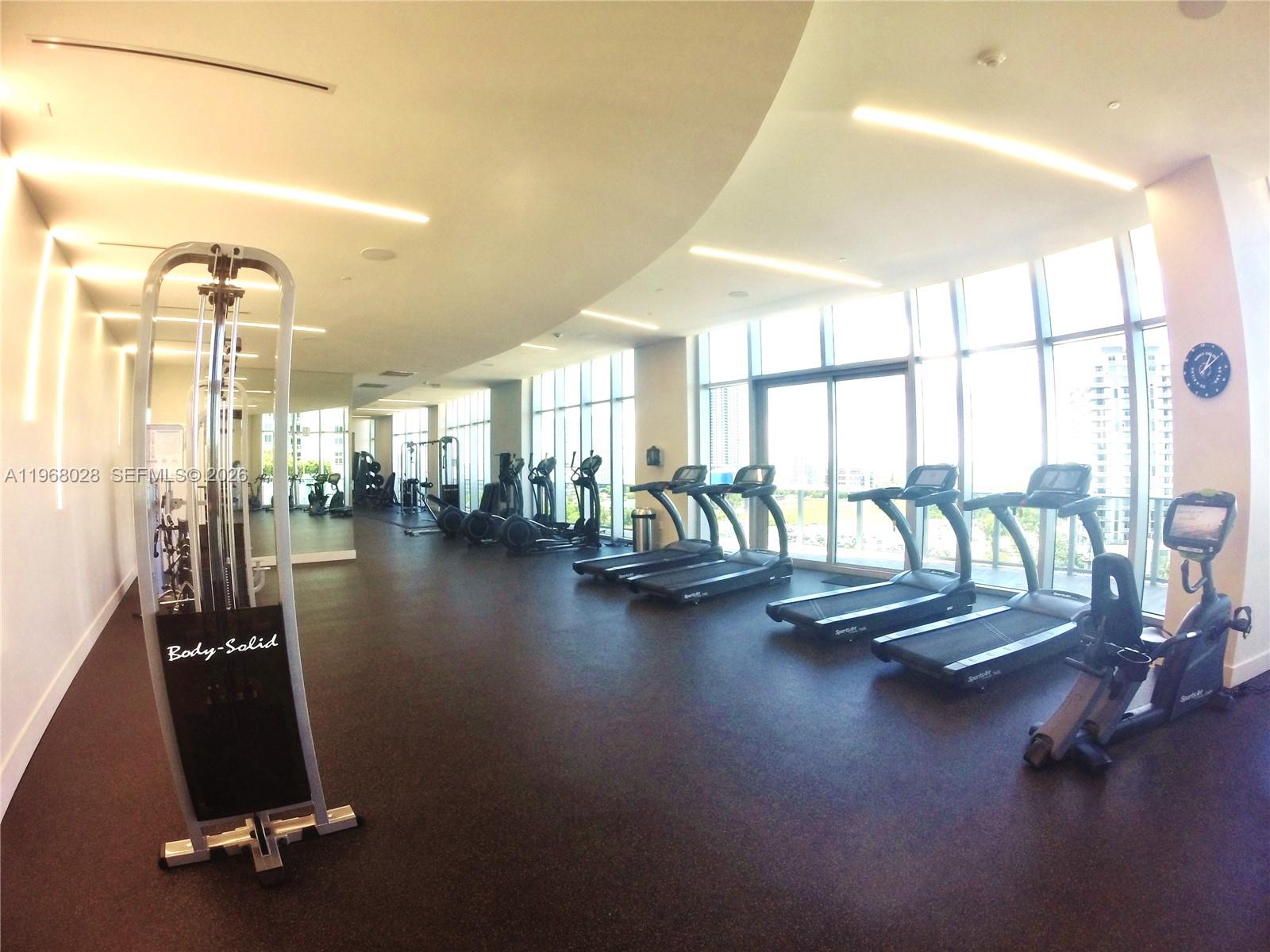 488 Northeast 18th Street, Unit 2001 Miami, FL 33132 - Photo 22 of 26 a view of a room with gym equipment