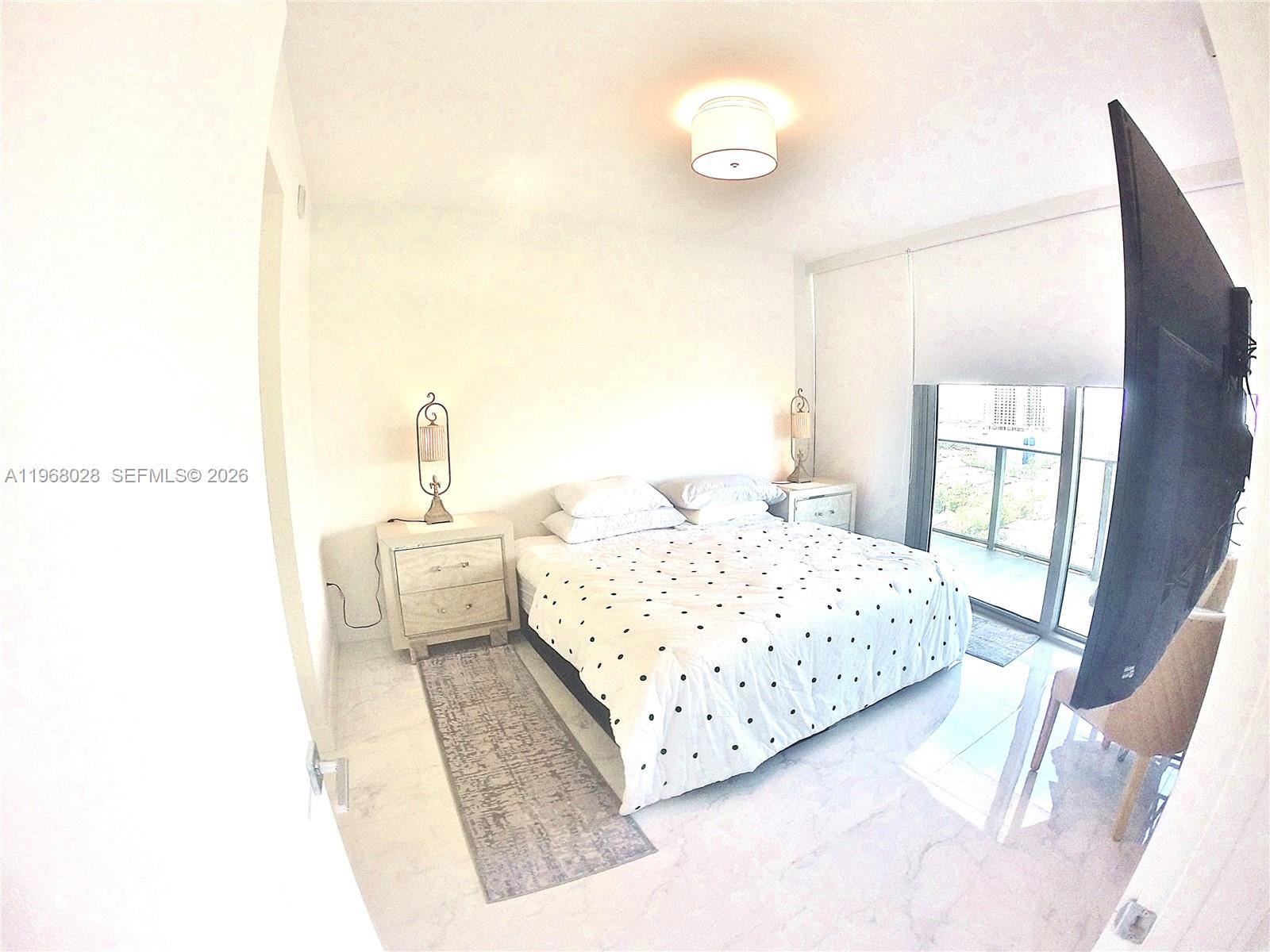 488 Northeast 18th Street, Unit 2001 Miami, FL 33132 - Photo 7 of 26 a bedroom with a bed and a window