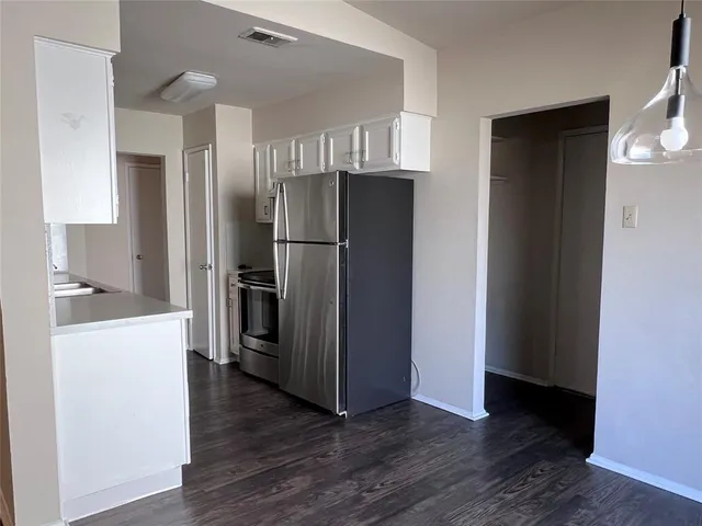 a kitchen with a refrigerator and a sink