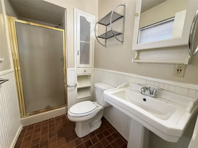 a white toilet sitting next to a bathroom sink