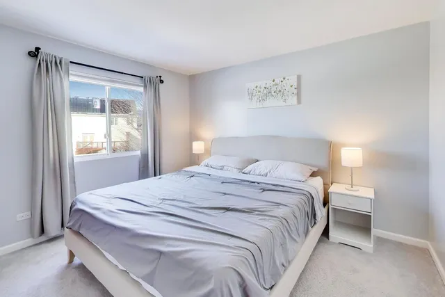 a bedroom with a large bed and a window