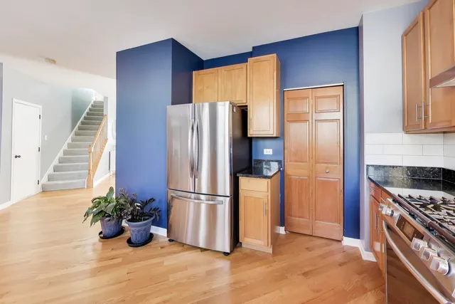 a kitchen with a refrigerator and potted plant