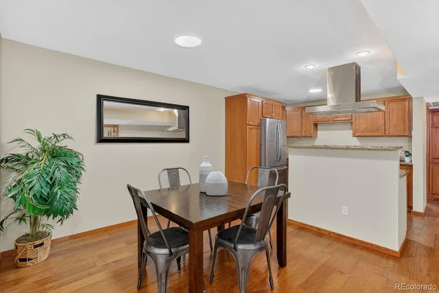 a dining room with furniture and wooden floor