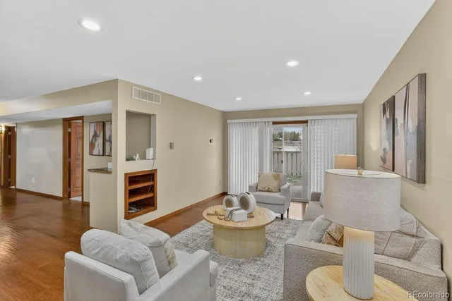 a living room with furniture and wooden floor