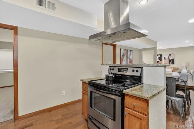 a kitchen with granite countertop a stove and a sink