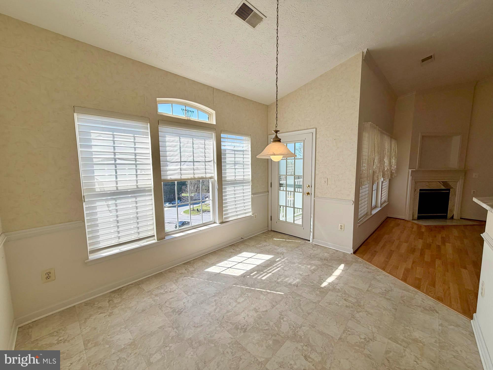 4501 Talcott Terrace, Unit 4501P Perry Hall, MD 21128 - Photo 11 of 21 a view of an empty room with a fireplace and a window