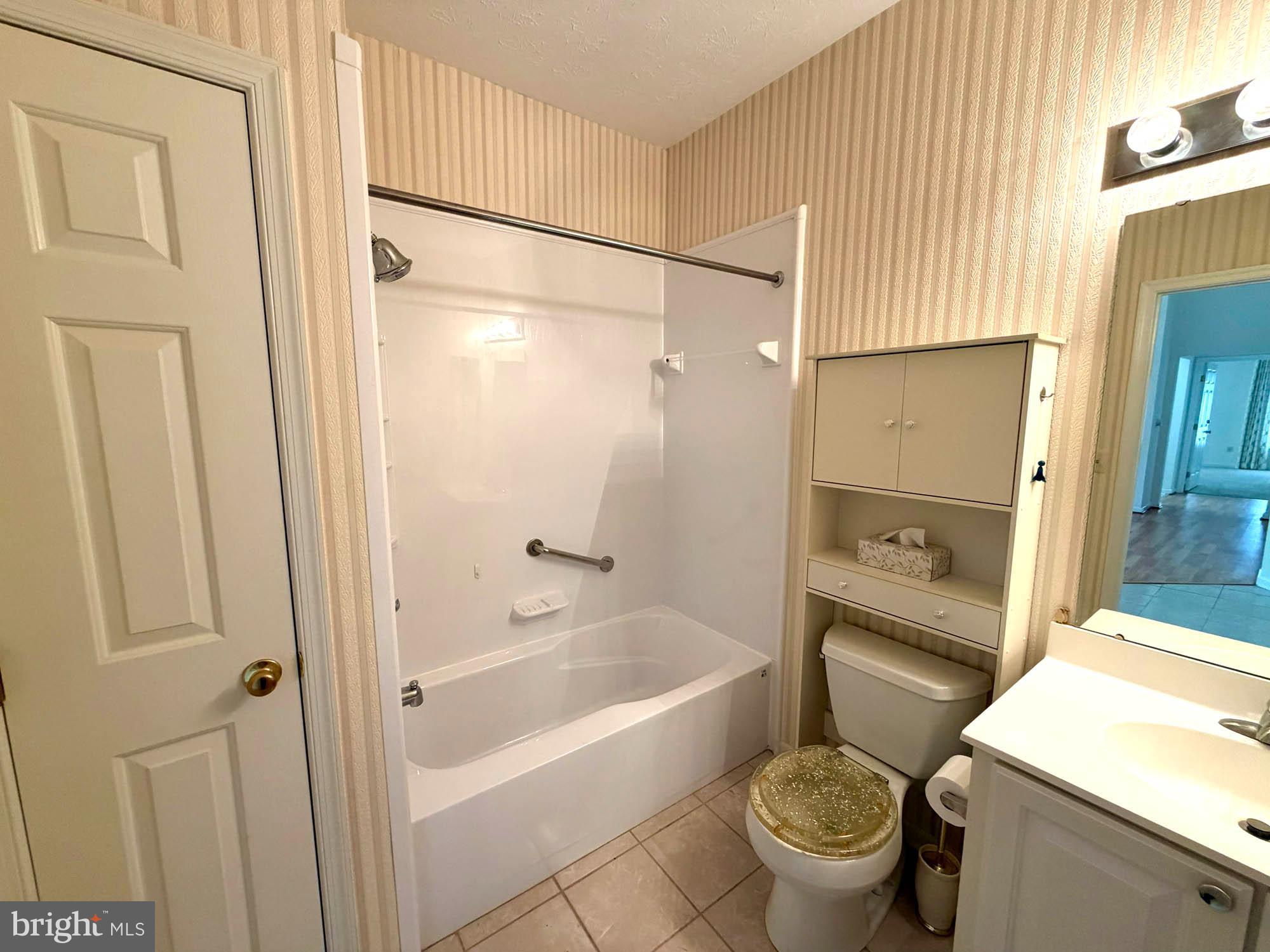 4501 Talcott Terrace, Unit 4501P Perry Hall, MD 21128 - Photo 19 of 21 a bathroom with a granite countertop sink toilet and shower