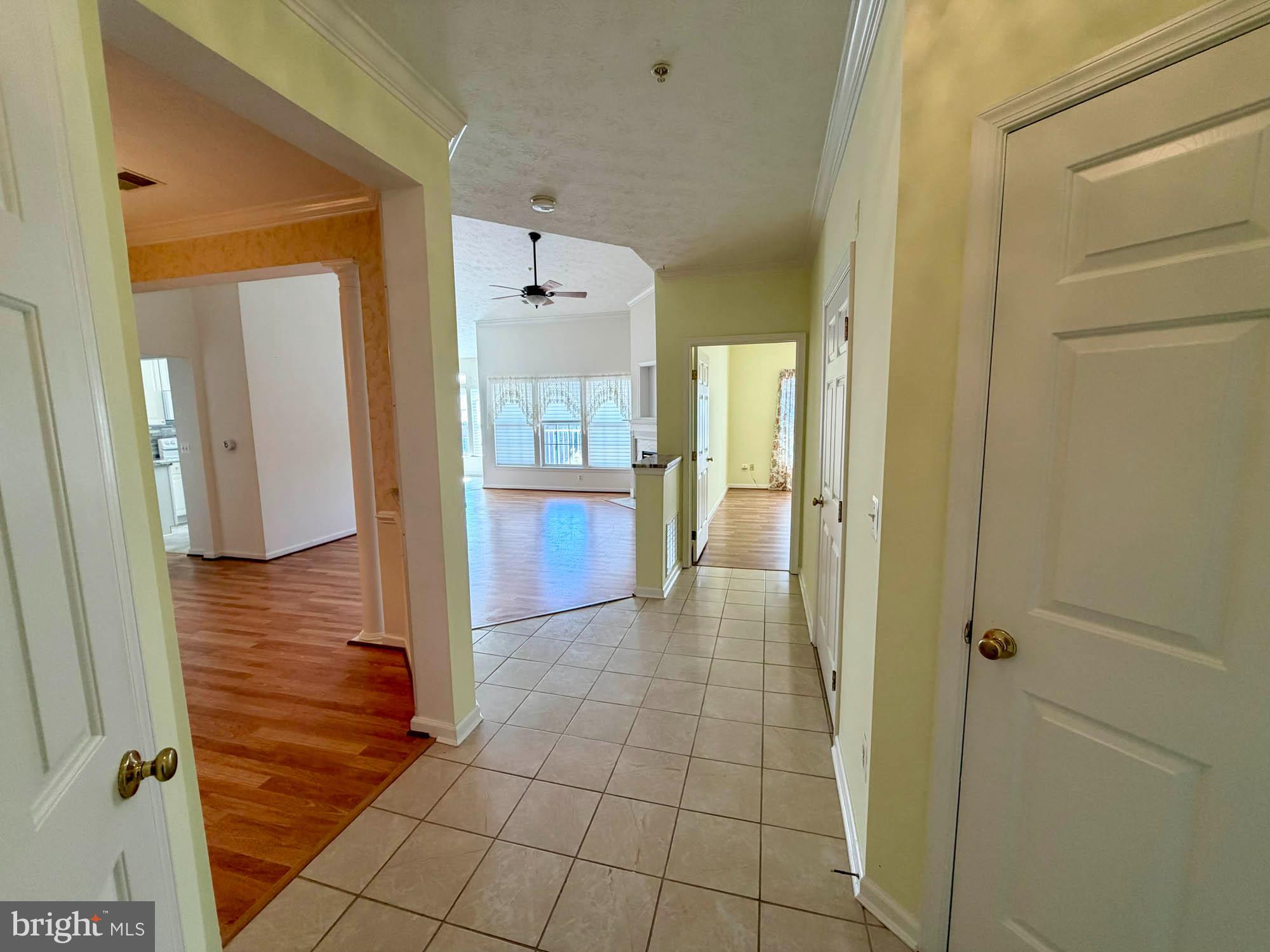 4501 Talcott Terrace, Unit 4501P Perry Hall, MD 21128 - Photo 6 of 21 a view of a hallway with wooden floor and a bathroom