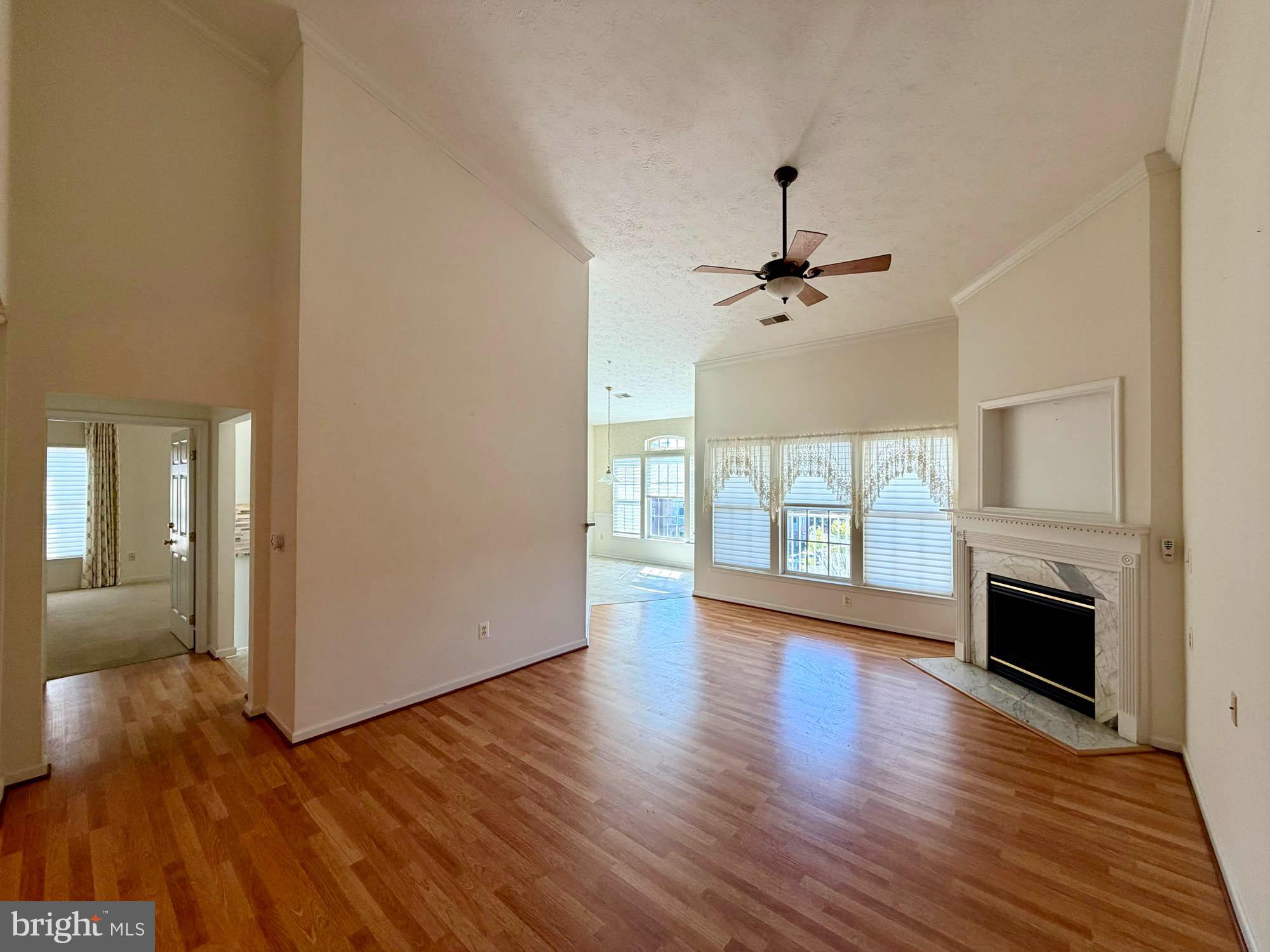 4501 Talcott Terrace, Unit 4501P Perry Hall, MD 21128 - Photo 7 of 21 a view of an empty room with a fireplace and wooden floor