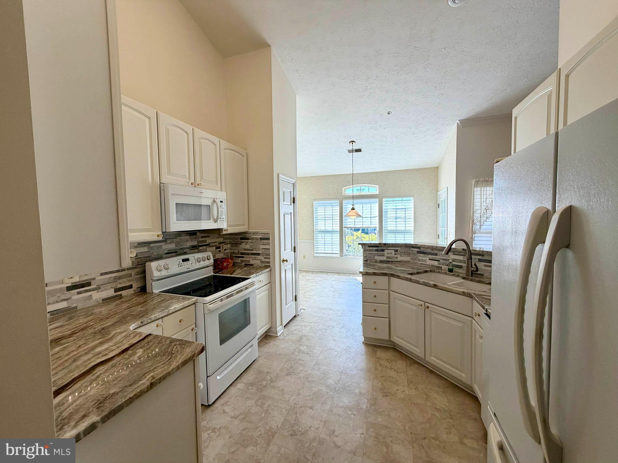 4501 Talcott Terrace, Unit 4501P Perry Hall, MD 21128 - Photo 9 of 21 a kitchen with stainless steel appliances granite countertop a stove a sink and a refrigerator