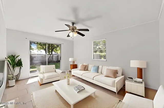 a living room with furniture and a large window