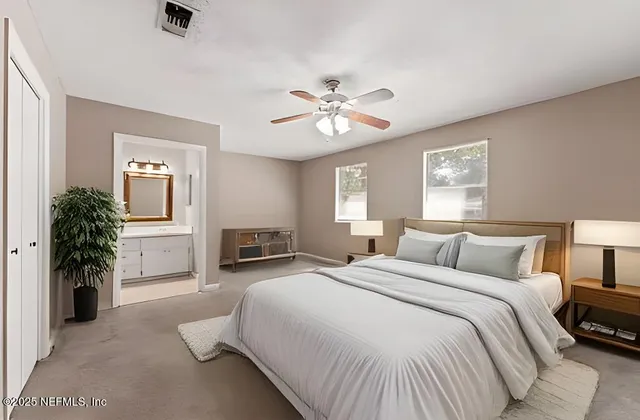 a spacious bedroom with a bed and a chandelier
