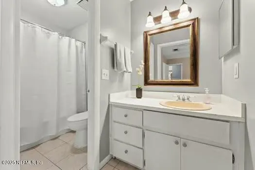 a bathroom with a double vanity sink mirror and toilet