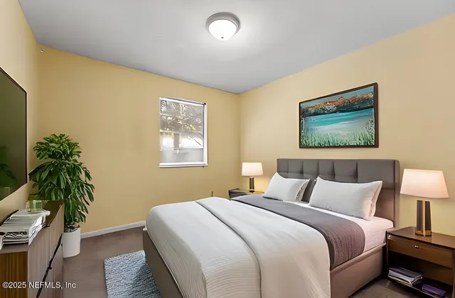 a bedroom with a bed and a potted plant