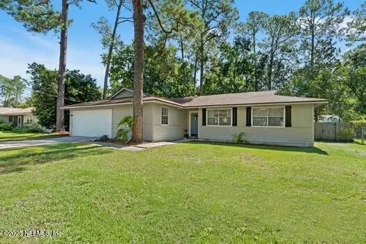 a view of a house with a backyard