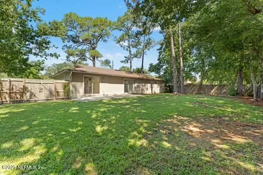 a front view of a house with yard and green space