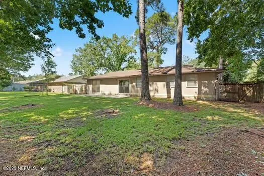a front view of a house with yard and green space