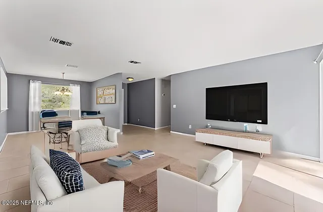 a living room with furniture and a flat screen tv