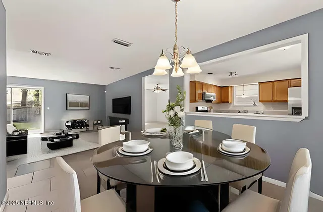 a view of a dining room with furniture and a chandelier