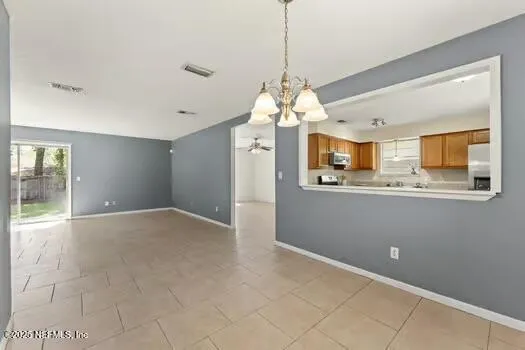 a view of a kitchen with granite countertop cabinets and a chandelier