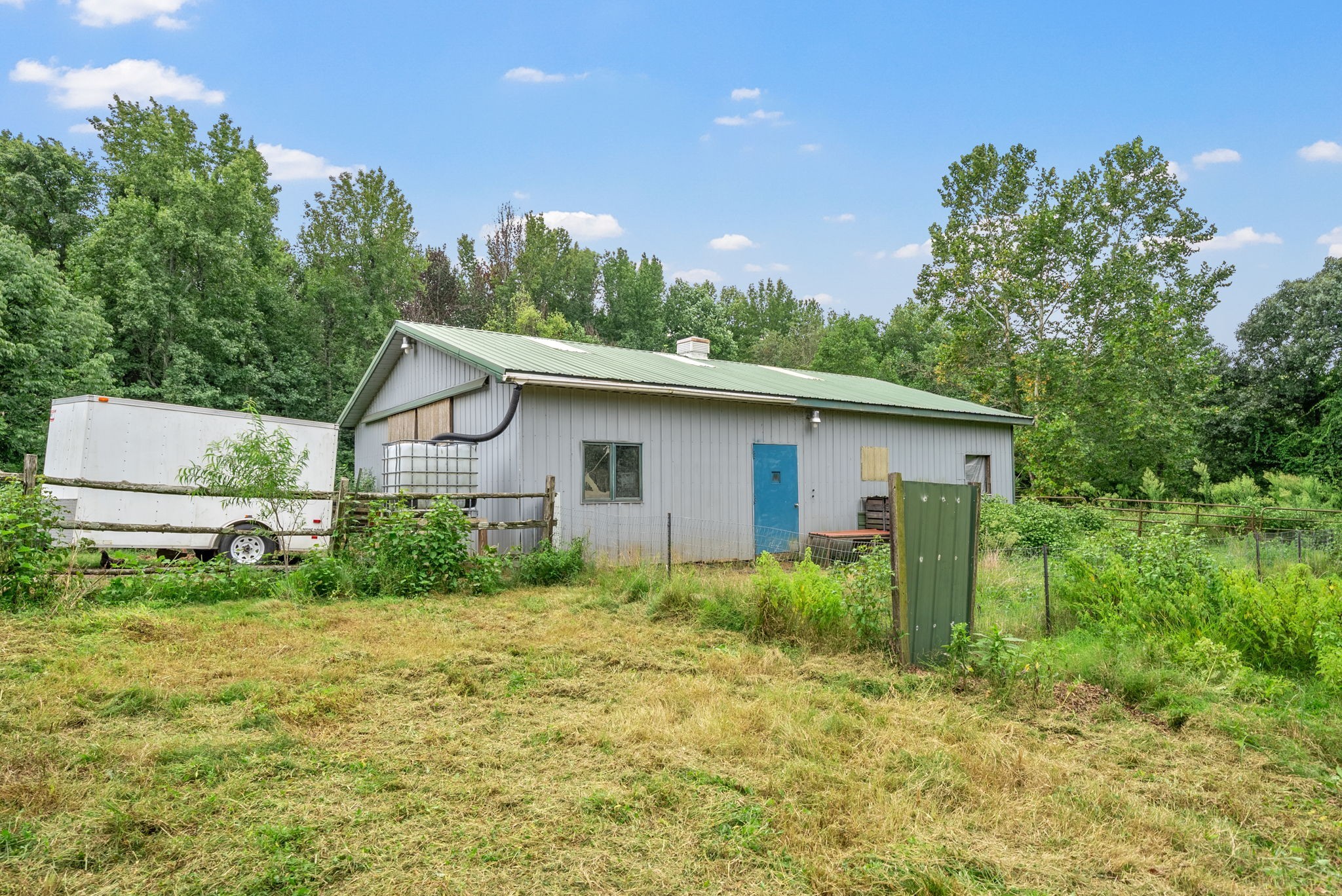 1205 Shakerag Road Hanson, KY 42413 - Photo 42 of 50 a backyard of a house with plants and large tree