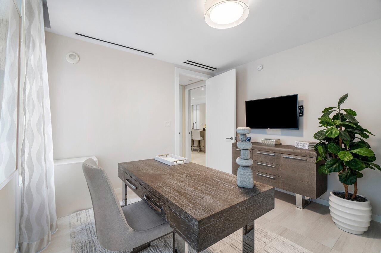 200 Southeast Mizner Boulevard, Unit 211 Boca Raton, FL 33432 - Photo 27 of 67 a living room with furniture and a flat screen tv