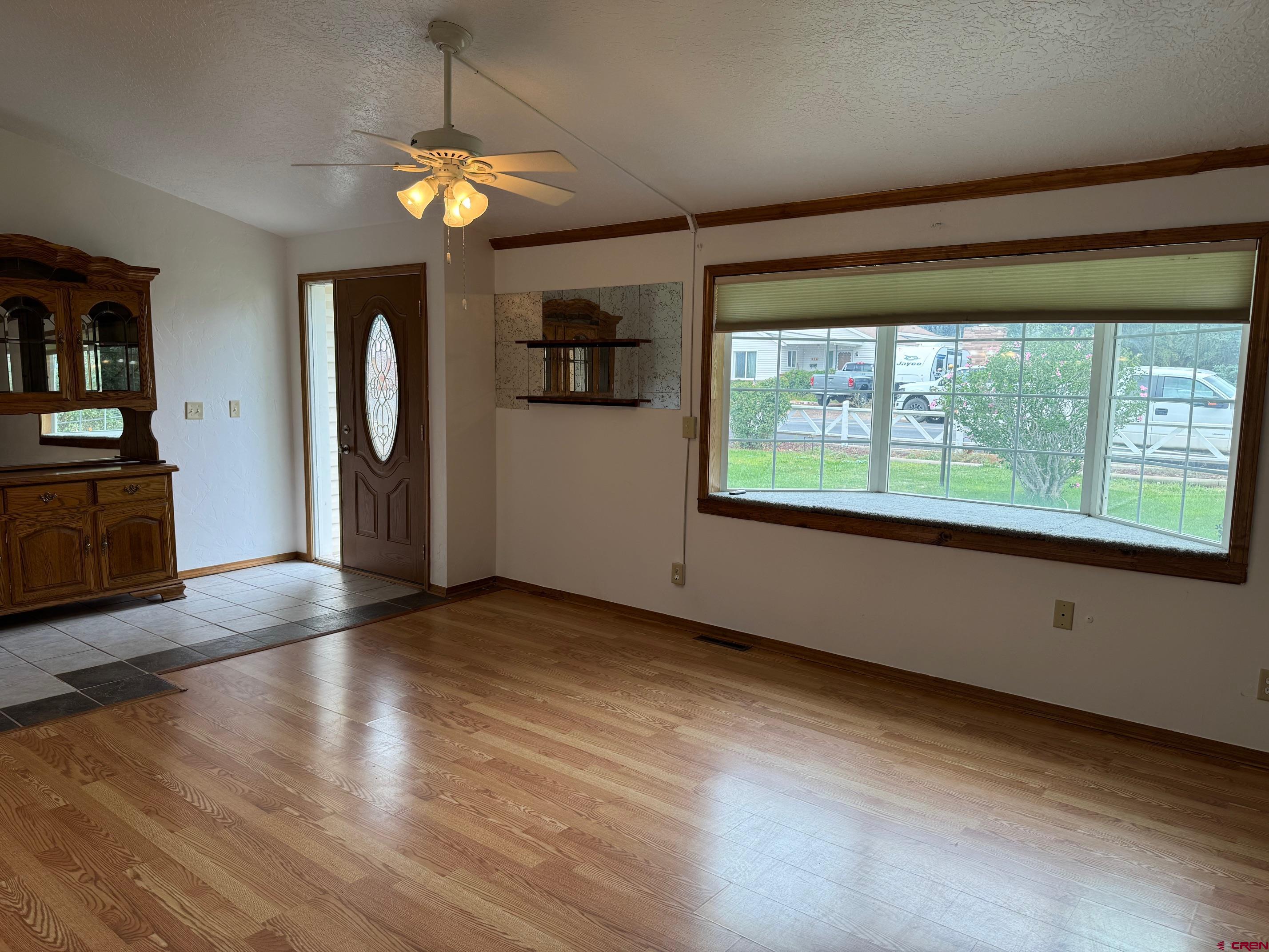 425 West 7th Street Cortez, CO 81321 - Photo 11 of 22 a view of an empty room with window and wooden floor