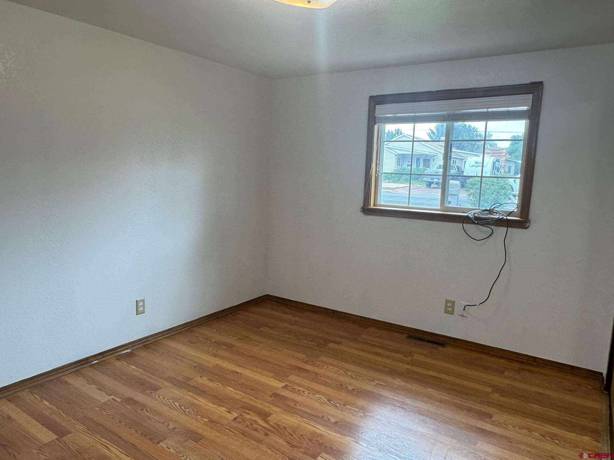 425 West 7th Street Cortez, CO 81321 - Photo 14 of 22 a view of a room with wooden floor and window