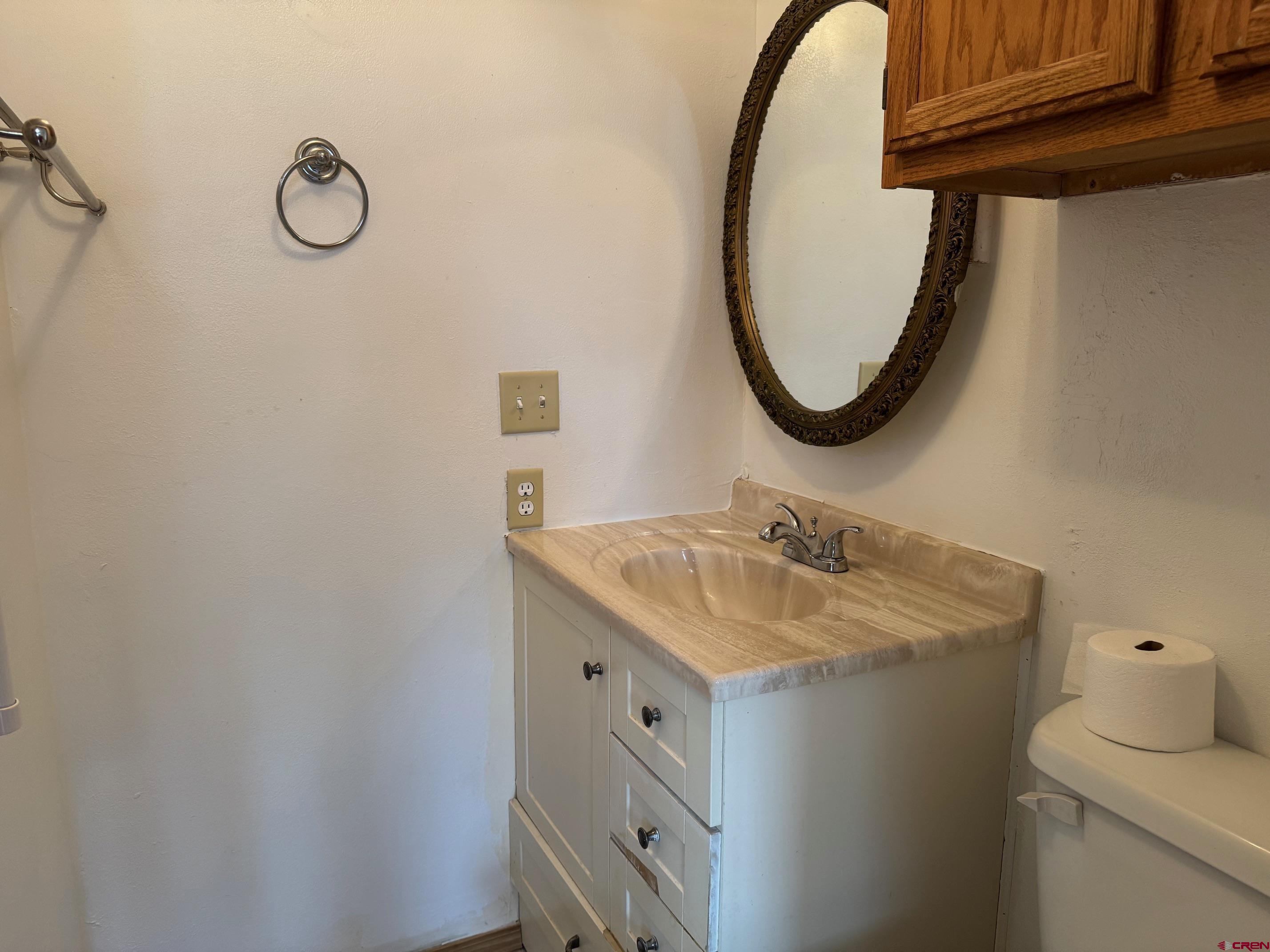 425 West 7th Street Cortez, CO 81321 - Photo 15 of 22 a bathroom with a sink and a mirror