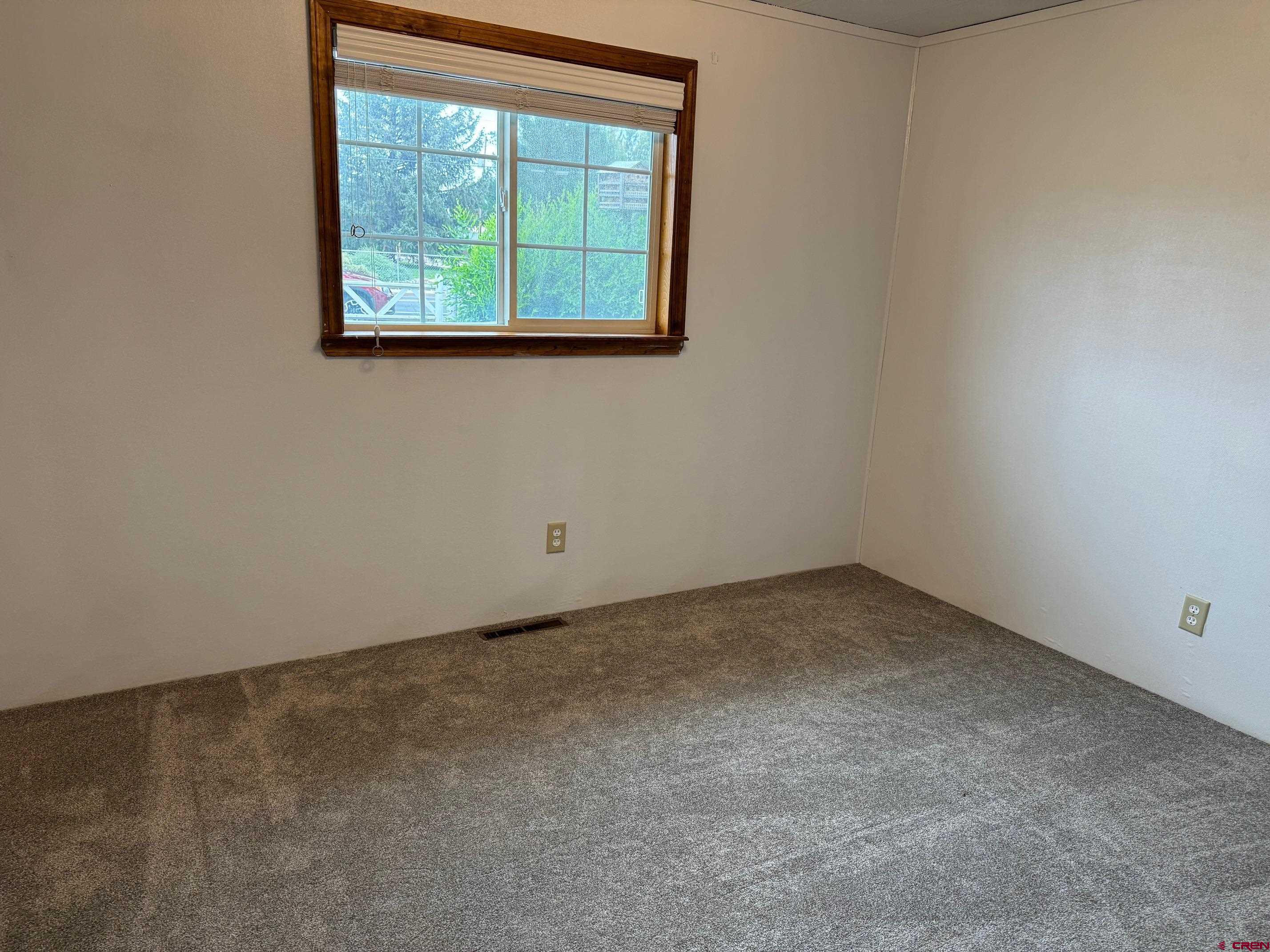 425 West 7th Street Cortez, CO 81321 - Photo 16 of 22 an empty room with a window