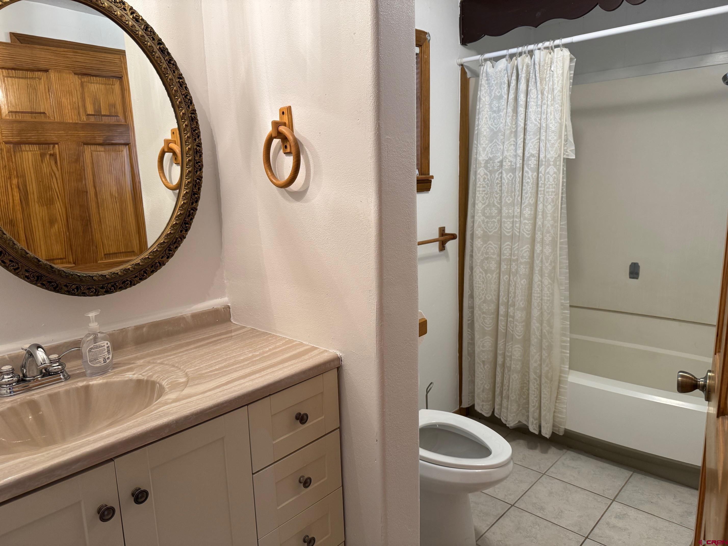 425 West 7th Street Cortez, CO 81321 - Photo 18 of 22 a bathroom with a granite countertop sink toilet and shower