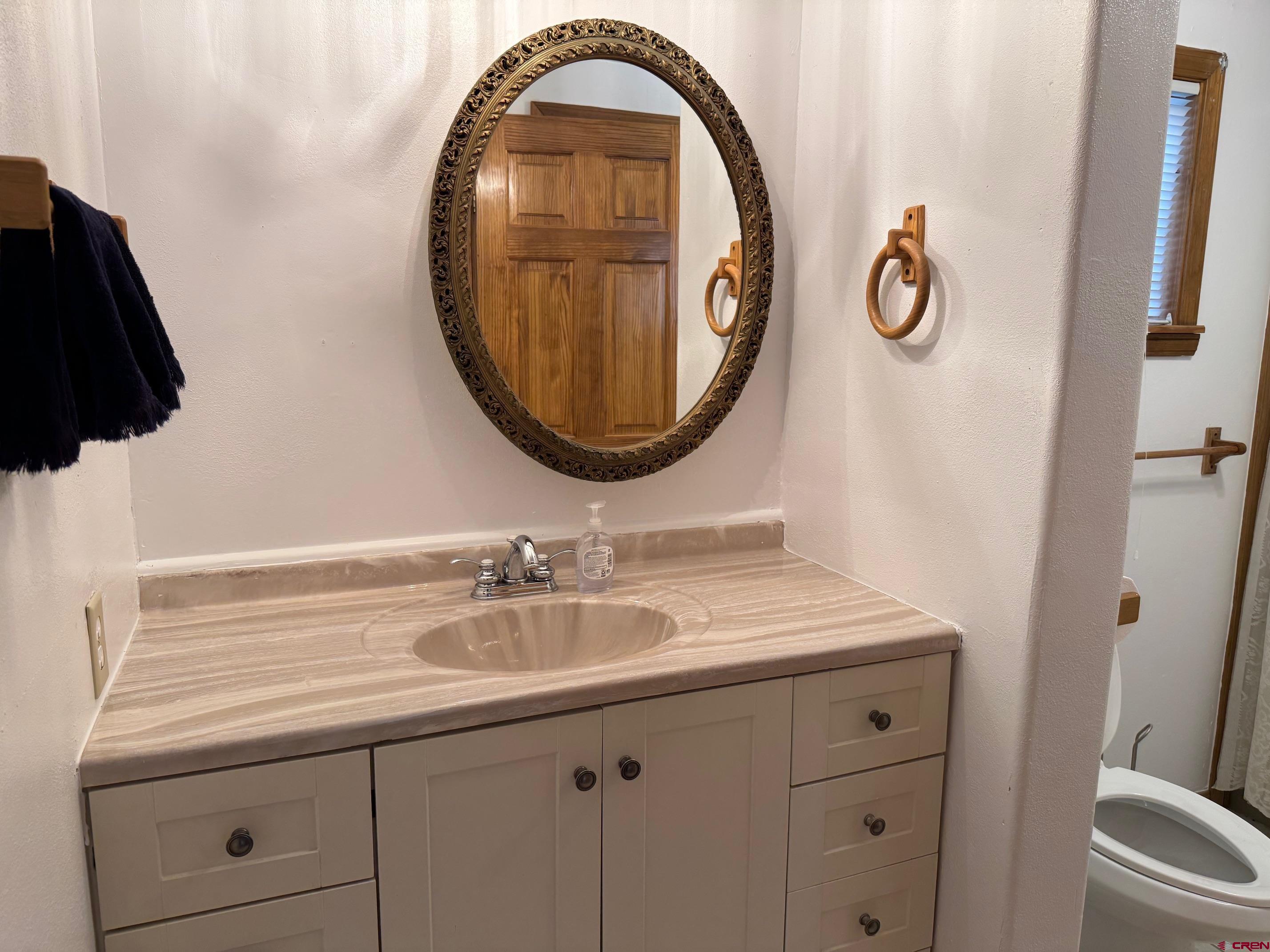 425 West 7th Street Cortez, CO 81321 - Photo 19 of 22 a bathroom with a sink and a mirror