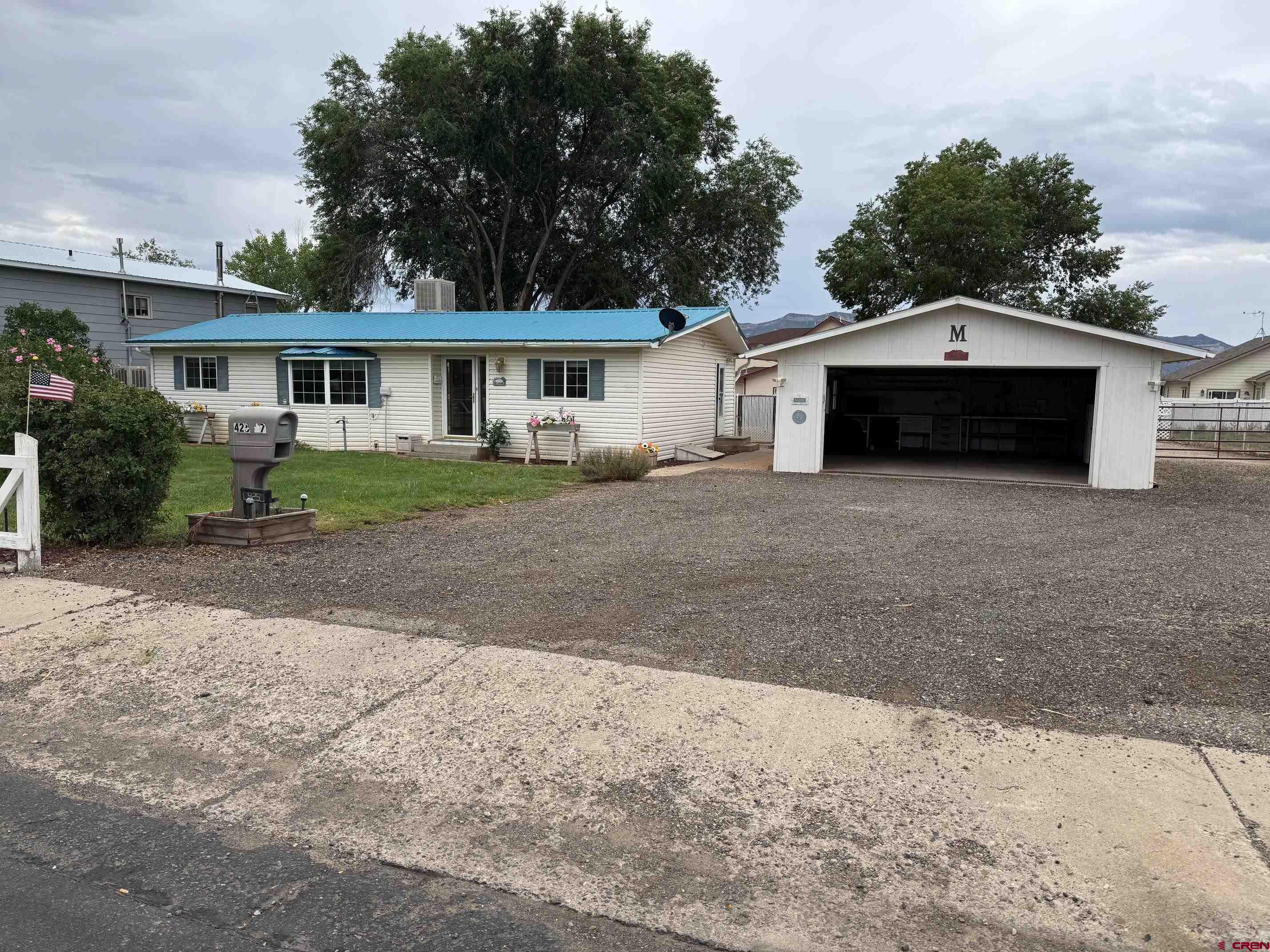 425 West 7th Street Cortez, CO 81321 - Photo 2 of 22 a front view of a house with a garden