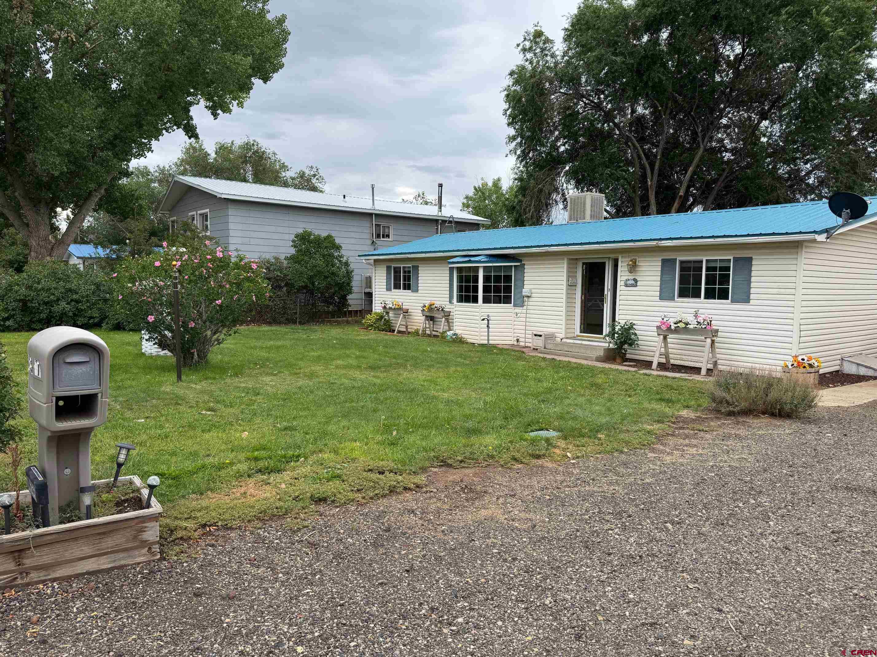 425 West 7th Street Cortez, CO 81321 - Photo 3 of 22 a view of a house with backyard and sitting area