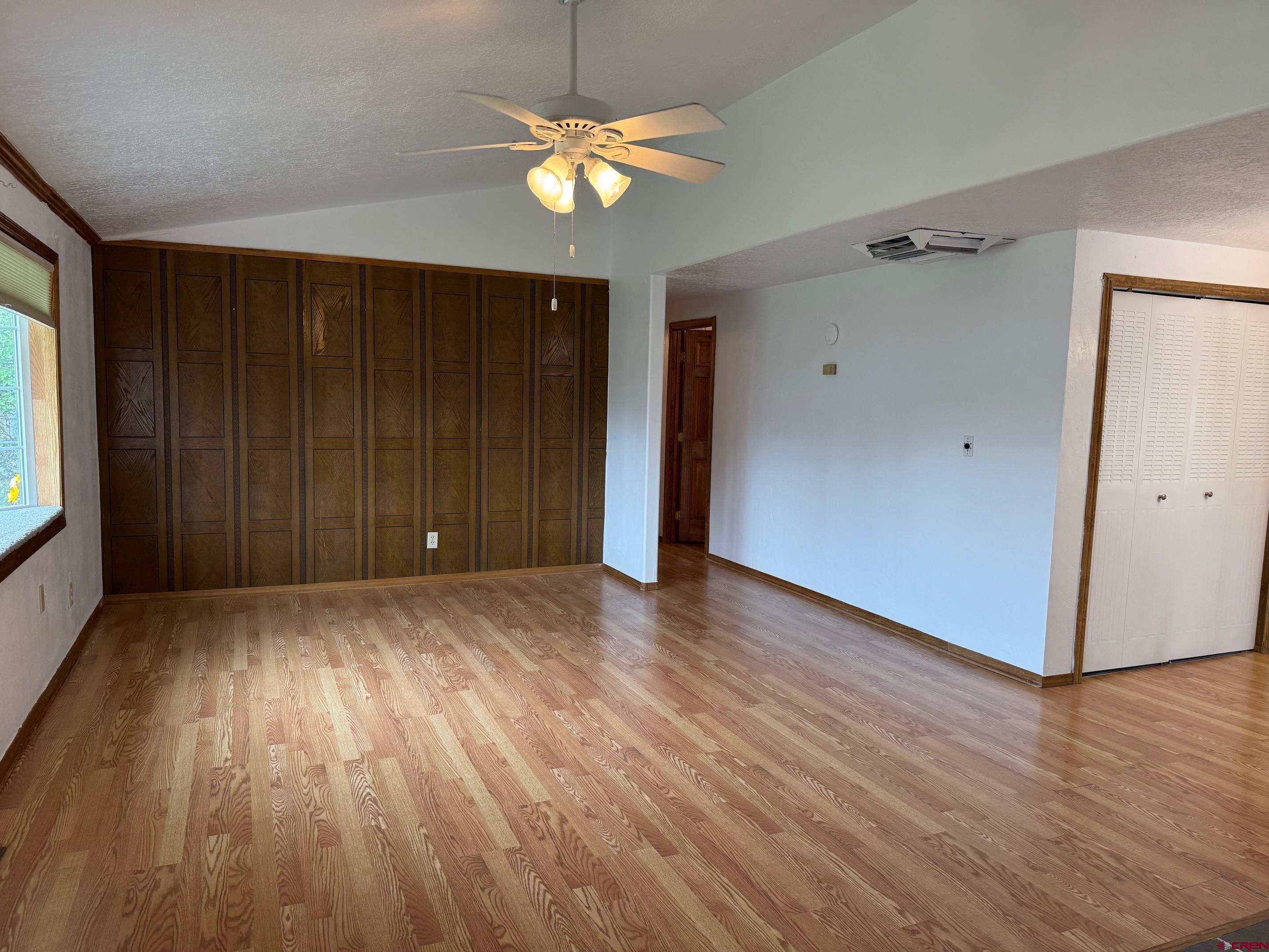 425 West 7th Street Cortez, CO 81321 - Photo 9 of 22 an empty room with wooden floor and windows