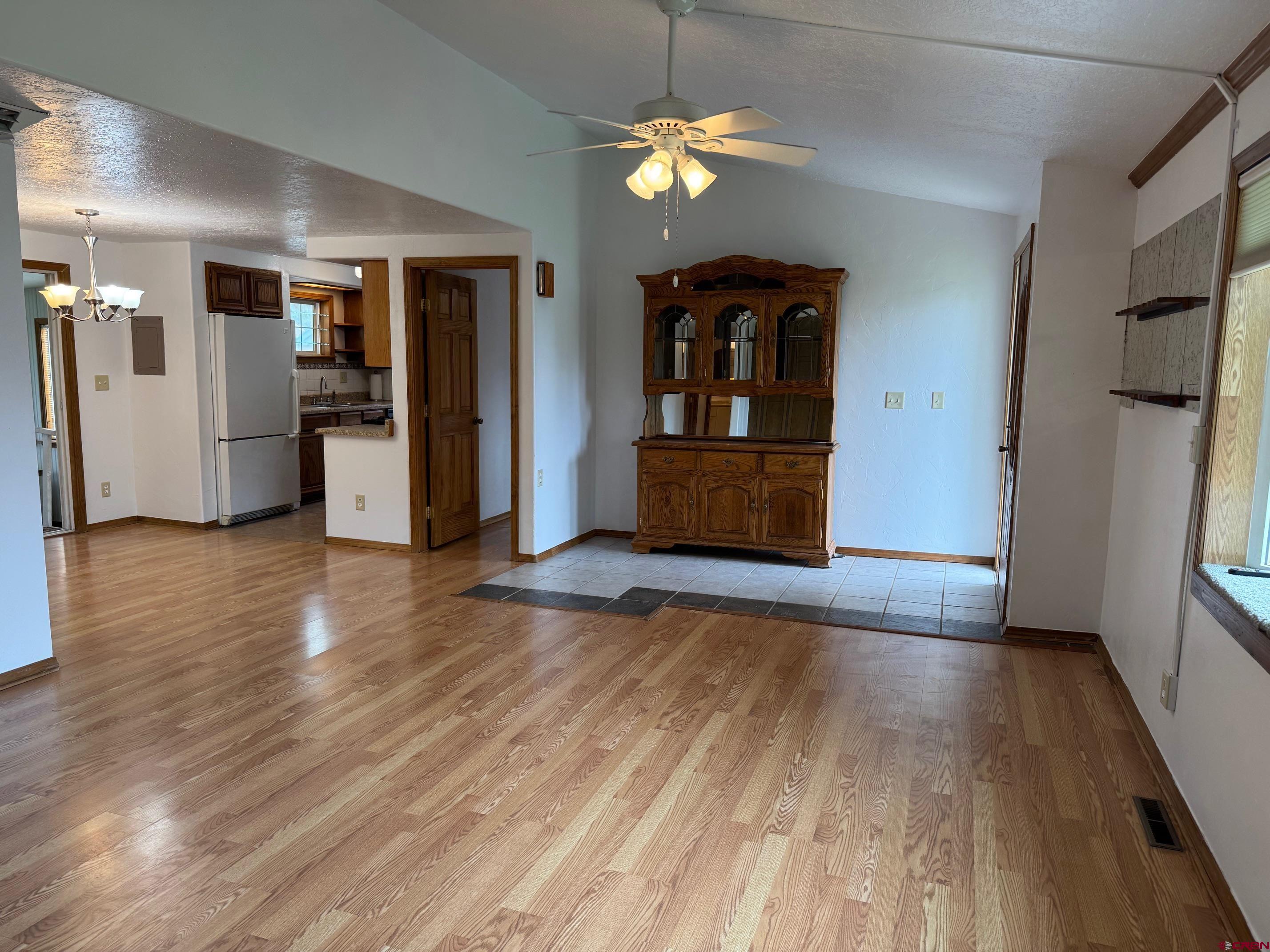 425 West 7th Street Cortez, CO 81321 - Photo 10 of 22 a view of a kitchen with flat screen tv and refrigerator