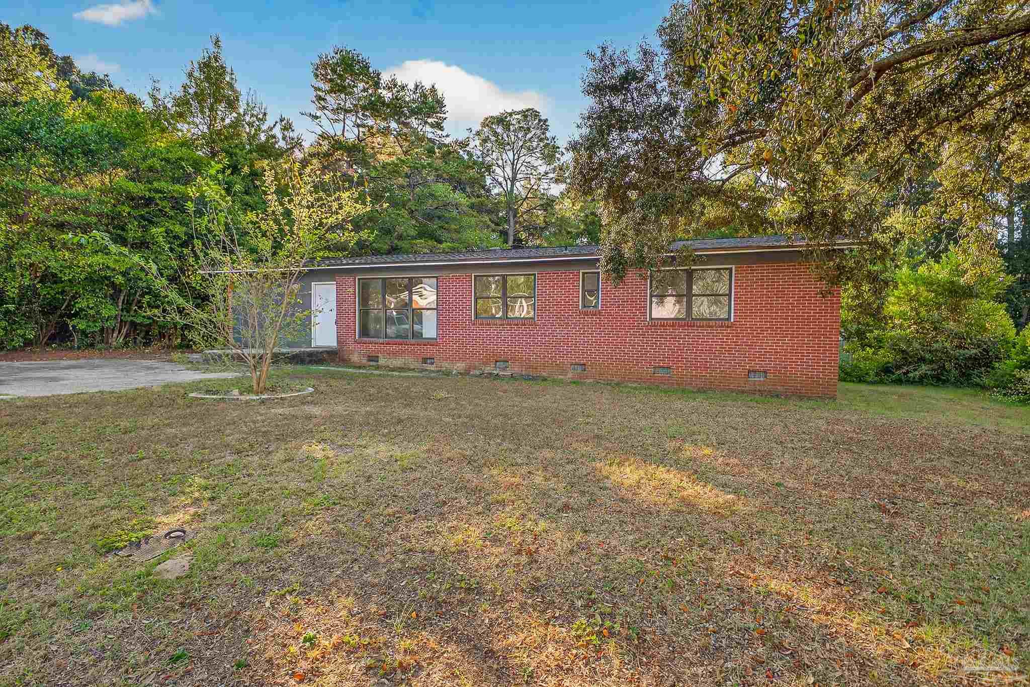6571 Cedar Street Milton, FL 32570 - Photo 1 of 47 a front view of house with yard and trees around