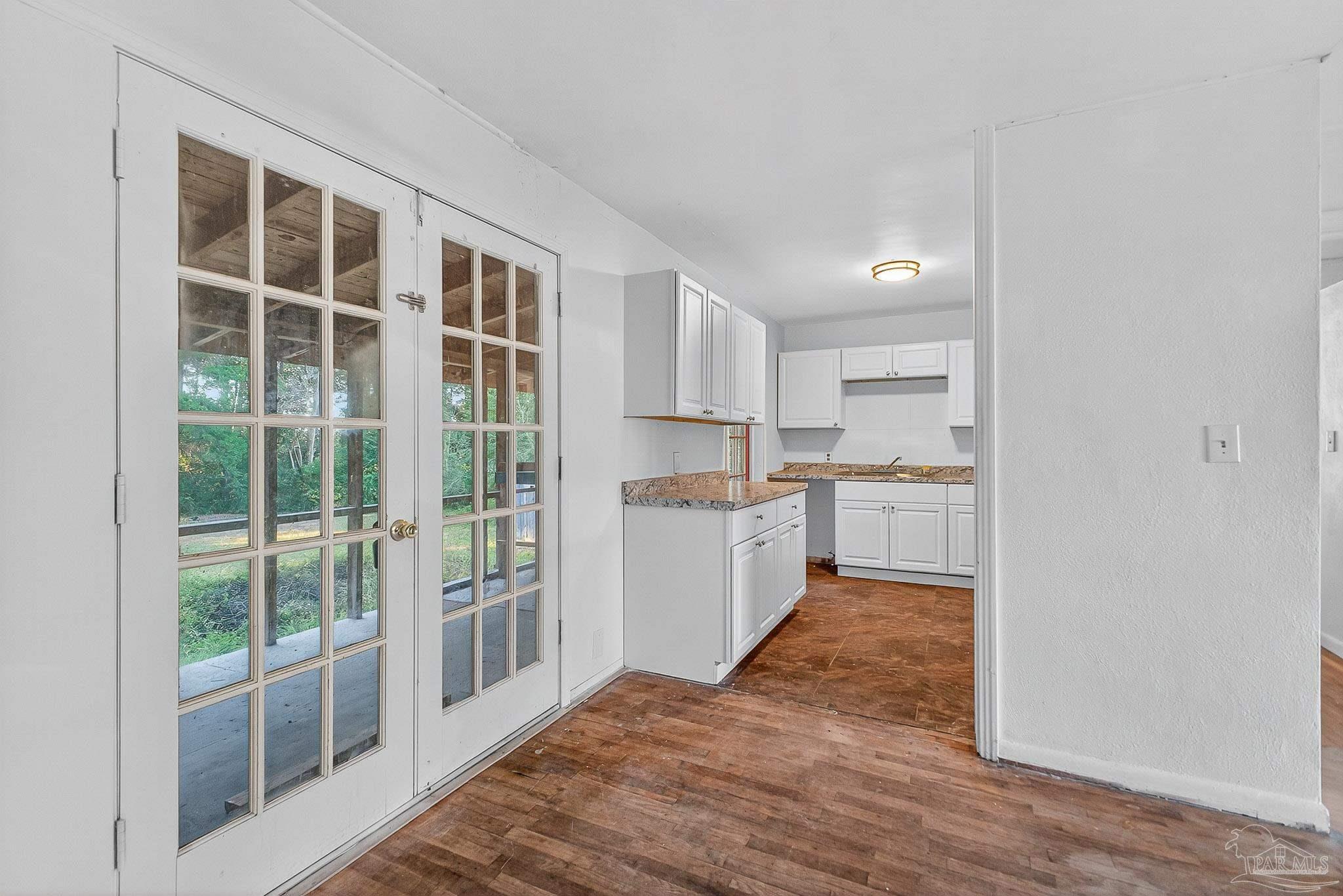 6571 Cedar Street Milton, FL 32570 - Photo 11 of 47 a view of a kitchen with wooden floor and windows