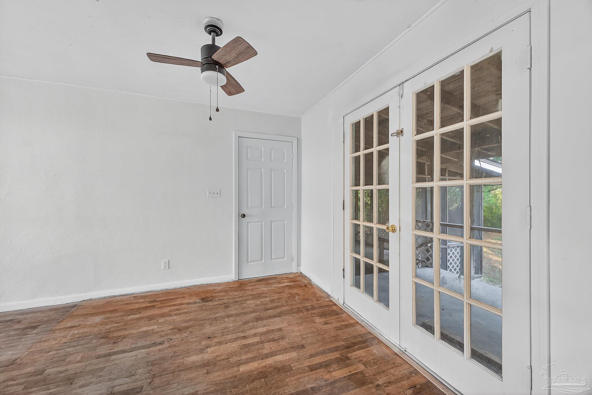 6571 Cedar Street Milton, FL 32570 - Photo 12 of 47 a view of empty room with wooden floor and windows