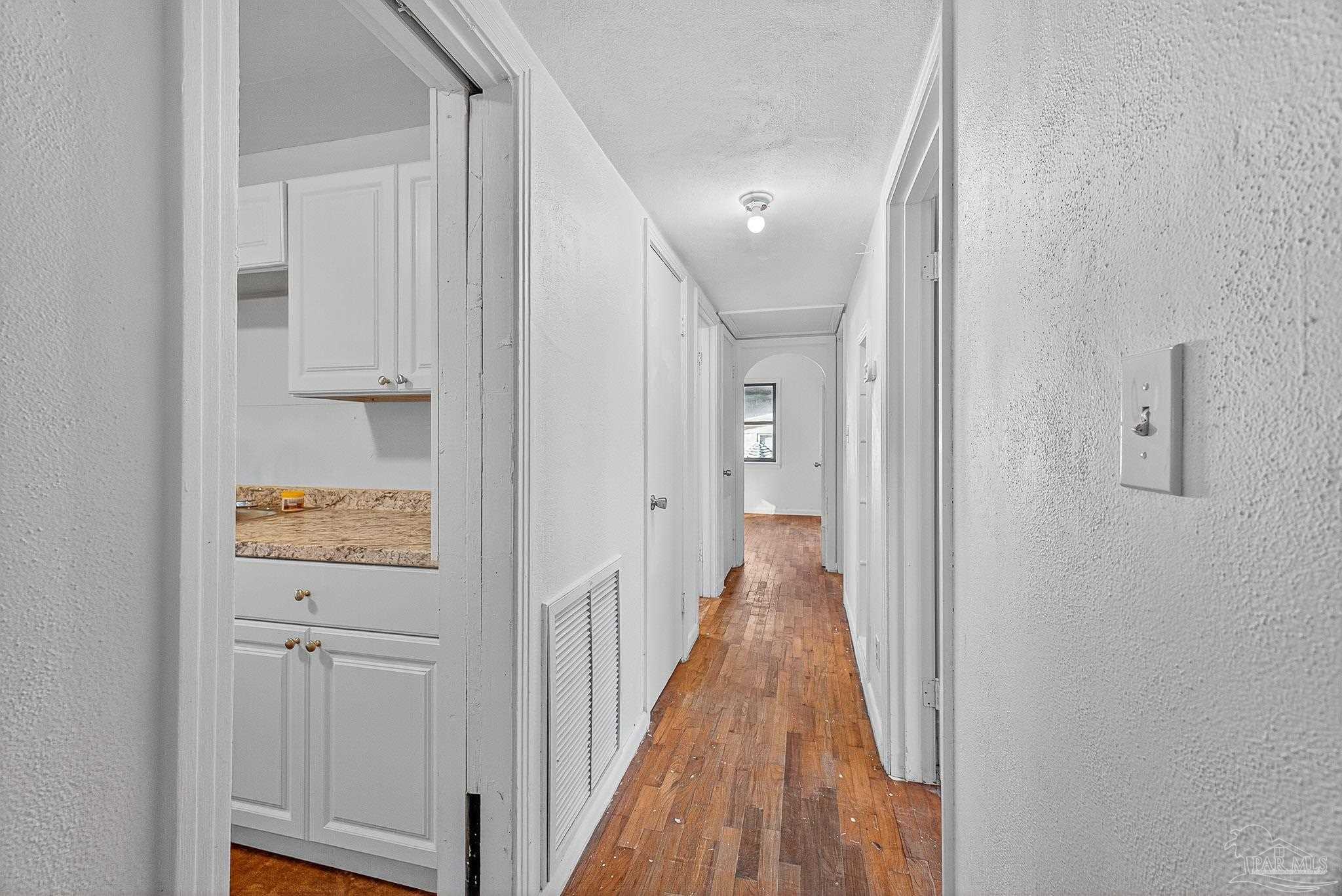 6571 Cedar Street Milton, FL 32570 - Photo 17 of 47 a view of a hallway with wooden floor