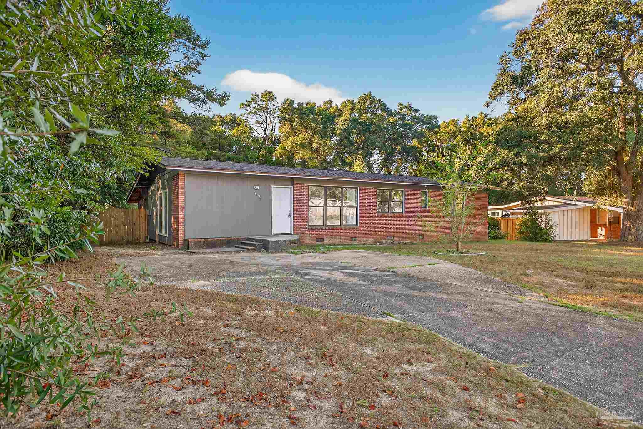 6571 Cedar Street Milton, FL 32570 - Photo 2 of 47 a view of a house with a yard and large tree
