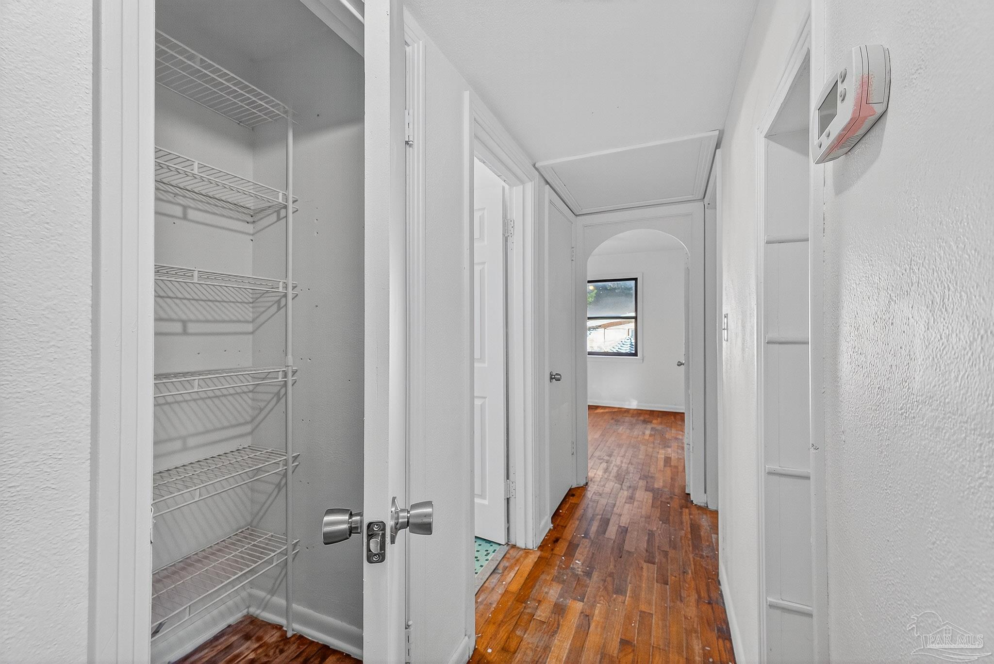 6571 Cedar Street Milton, FL 32570 - Photo 22 of 47 a view of a hallway with wooden floor and closet