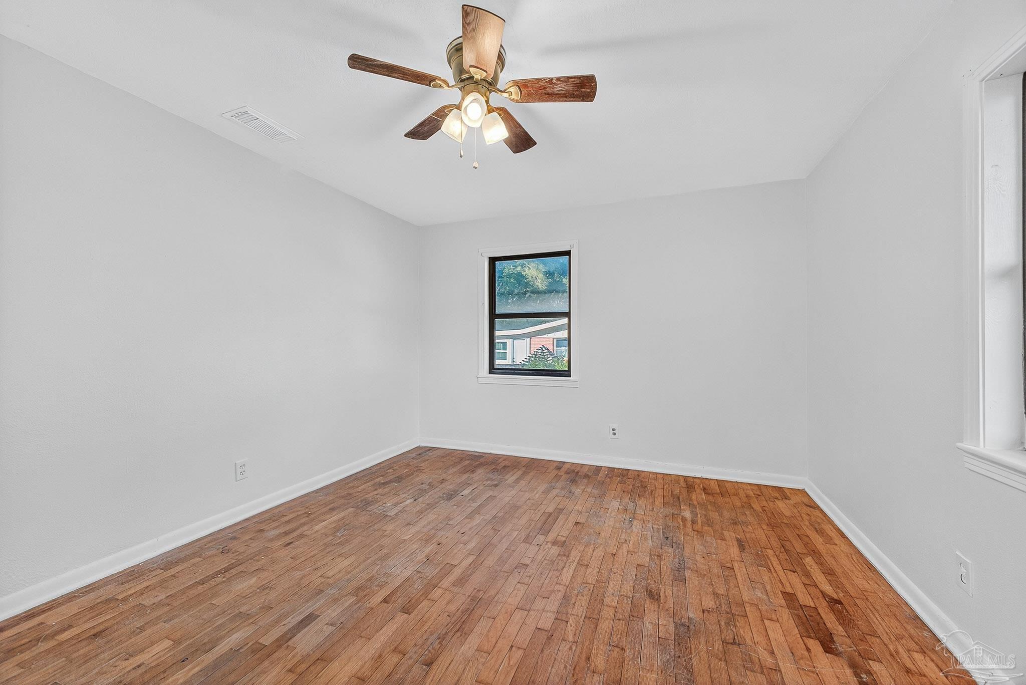 6571 Cedar Street Milton, FL 32570 - Photo 26 of 47 a view of empty room with wooden floor