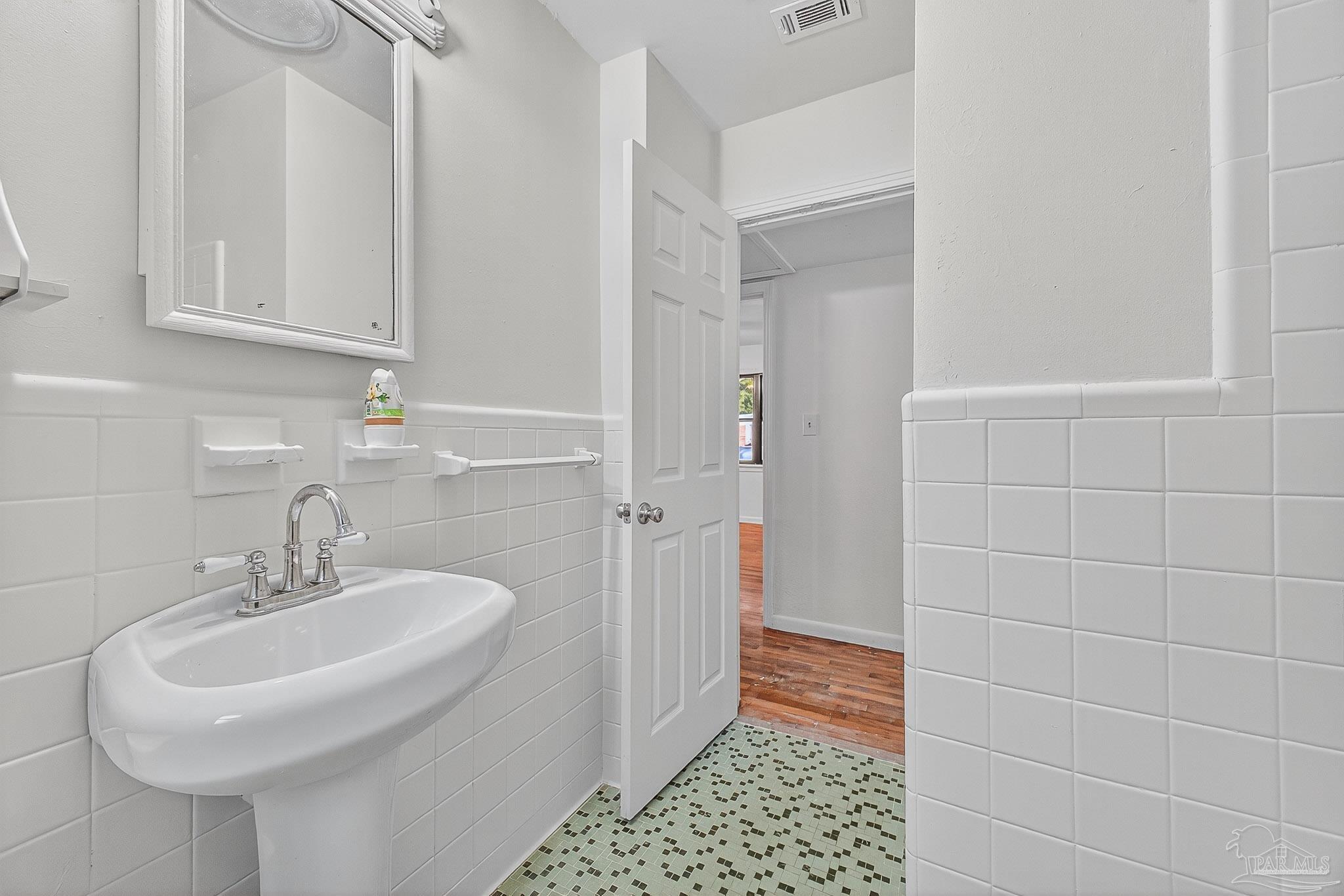 6571 Cedar Street Milton, FL 32570 - Photo 27 of 47 a bathroom with a sink and a mirror