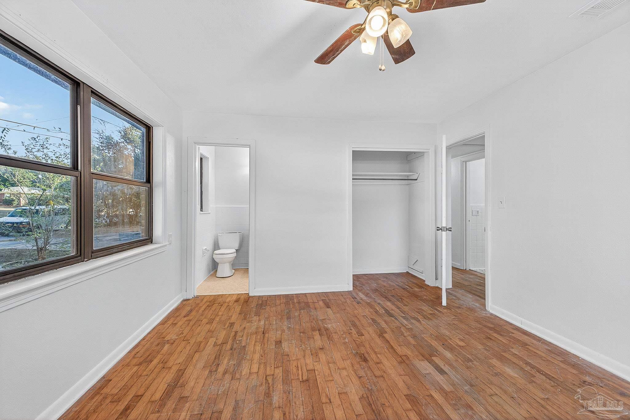 6571 Cedar Street Milton, FL 32570 - Photo 29 of 47 a view of empty room with wooden floor and fan