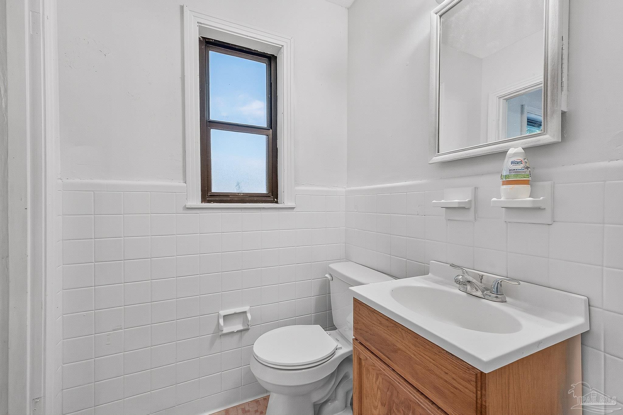 6571 Cedar Street Milton, FL 32570 - Photo 30 of 47 a bathroom with a toilet sink and mirror