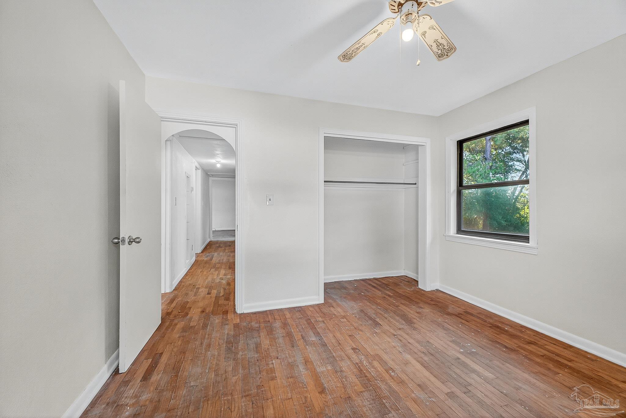 6571 Cedar Street Milton, FL 32570 - Photo 33 of 47 a view of a room with wooden floor ceiling fan and windows