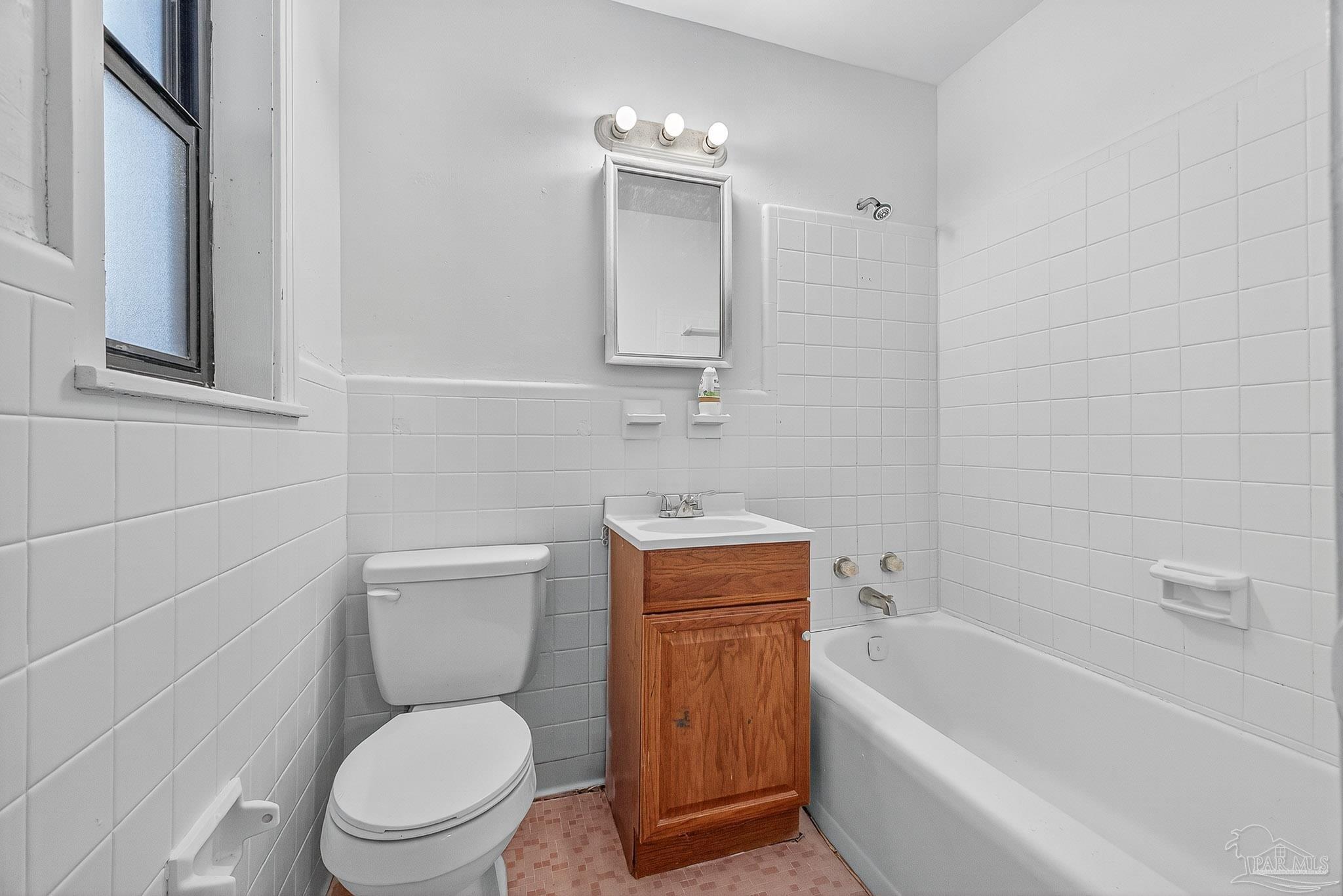 6571 Cedar Street Milton, FL 32570 - Photo 36 of 47 a white toilet sitting next to a bathtub