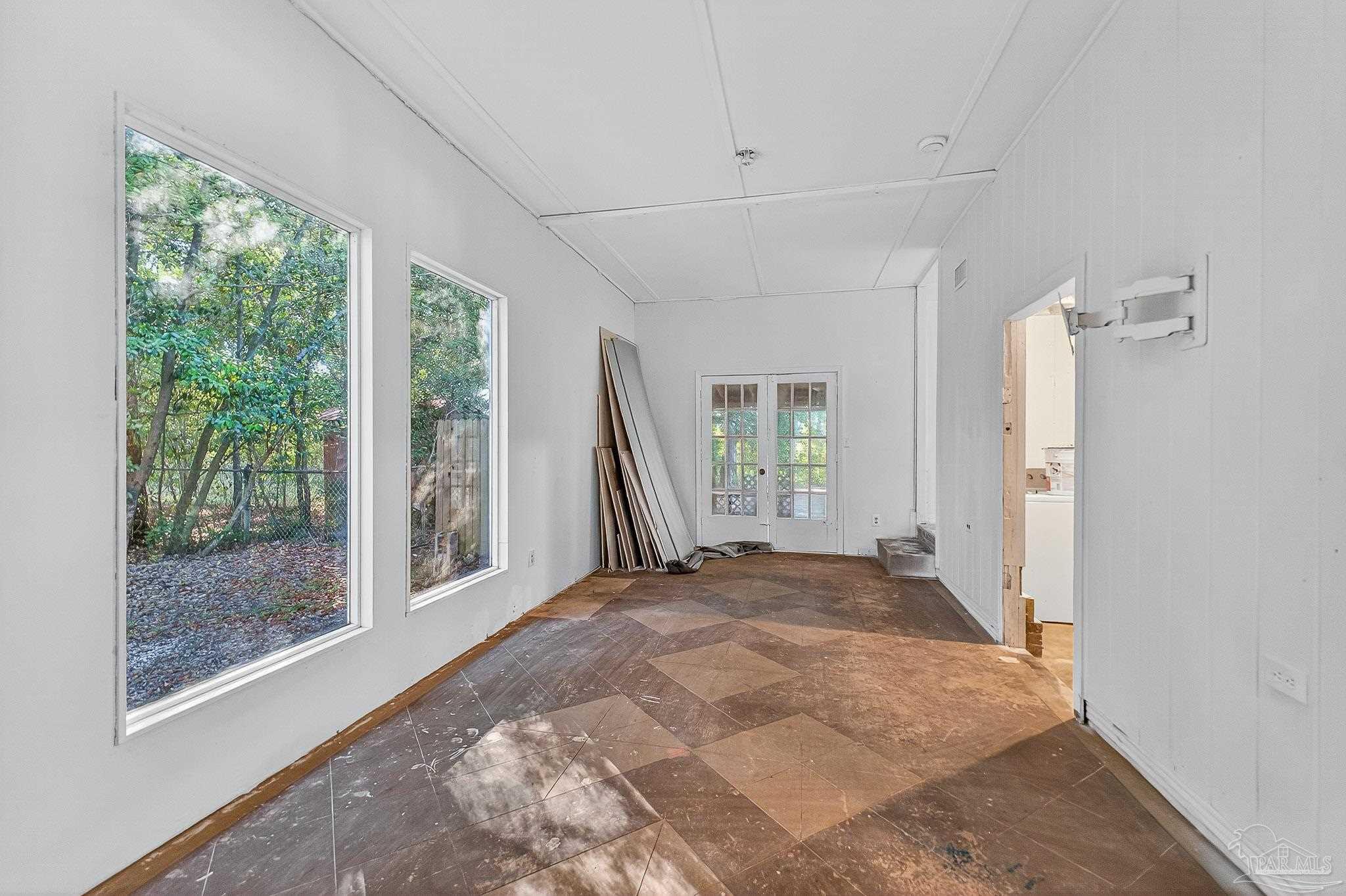 6571 Cedar Street Milton, FL 32570 - Photo 39 of 47 a view of a bedroom with a large window and front door