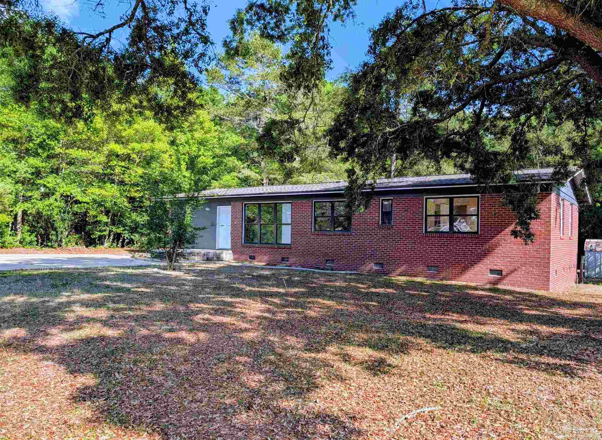 6571 Cedar Street Milton, FL 32570 - Photo 4 of 47 a view of a house with a yard